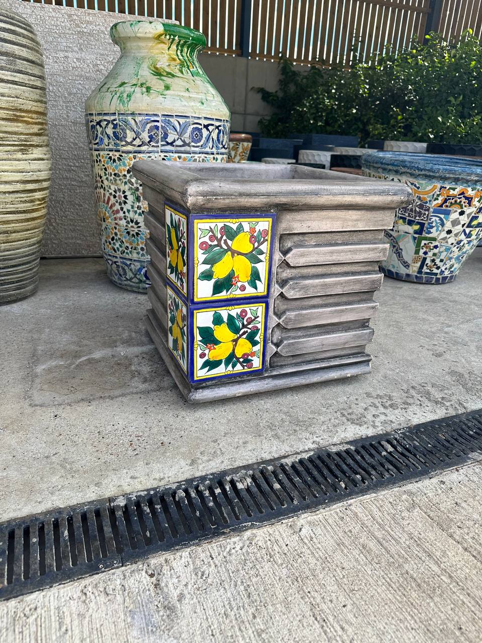 large square mosaic pot on a uk patio