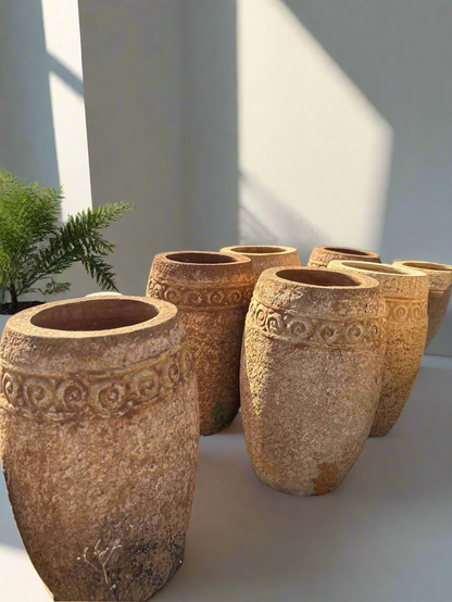 large aged stone pots in a uk garden